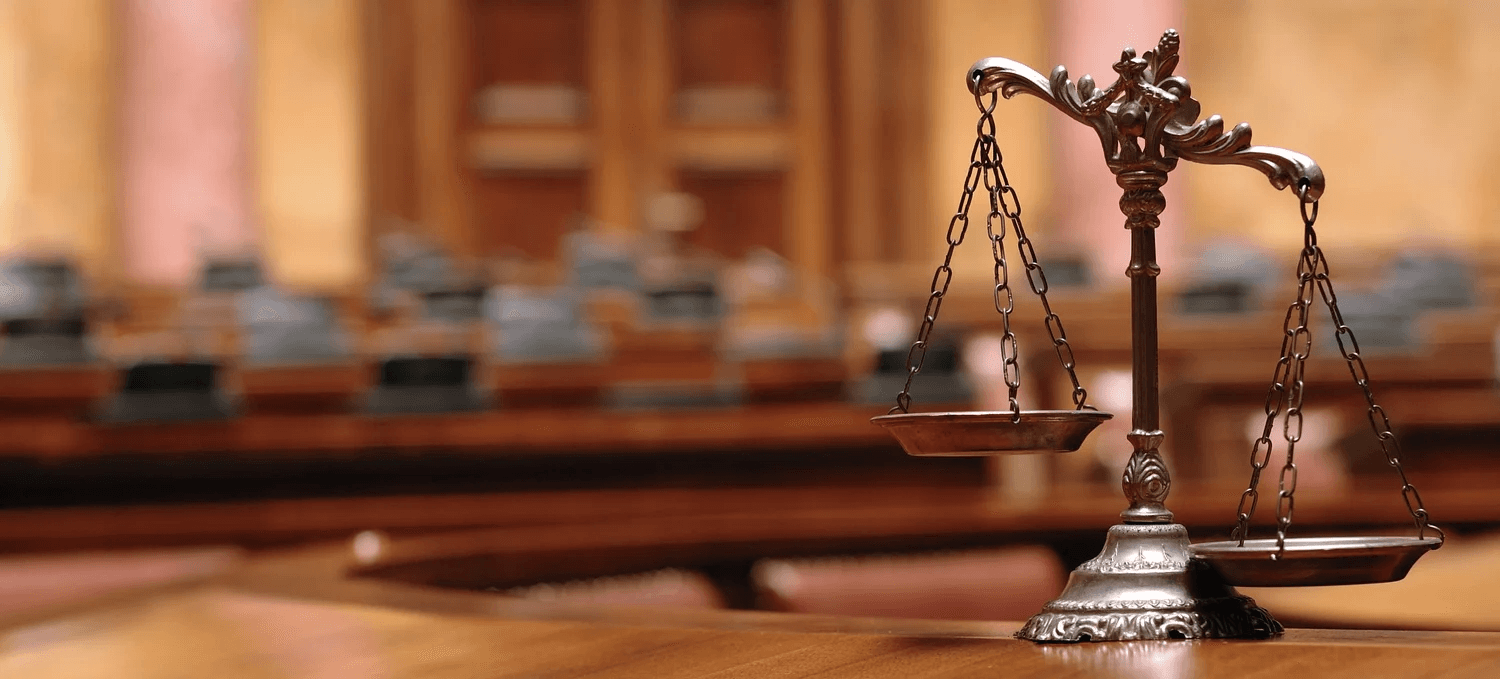 Brass scales of justice in a courtroom
